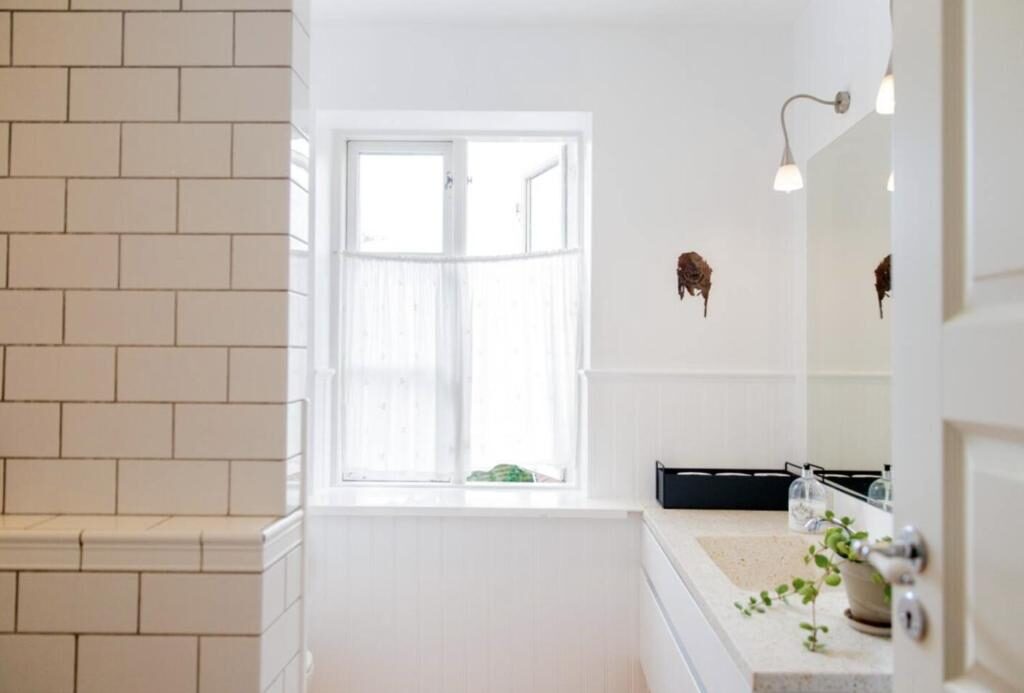 Light shared bathroom with classic white tiles